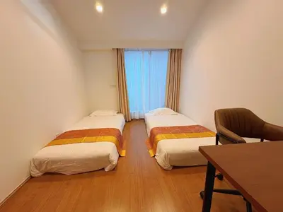 a room with two beds and a table and a desk at \u738b\u5b50Stay\u4f73 in Tokyo