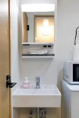 a bathroom with a sink and a microwave at LIFE TOWN Kameari in Tokyo