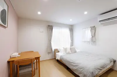 a bedroom with a bed and a desk and a window at LIFE TOWN Kameari in Tokyo