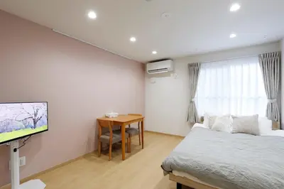 a bedroom with a bed and a desk and a tv at LIFE TOWN Kameari in Tokyo