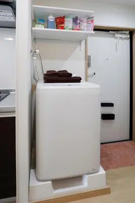 a white refrigerator with a tv in a kitchen at LIFE TOWN Kameari in Tokyo