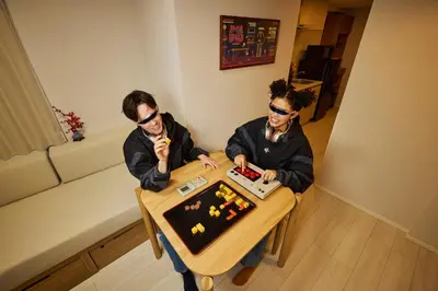 two people sitting at a table playing a game at Section L Akihabara in Tokyo