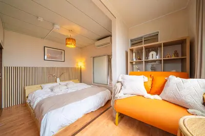 a bedroom with two beds and a couch at #34-Zen Home- \u6771\u745e\u6c5f in Tokyo