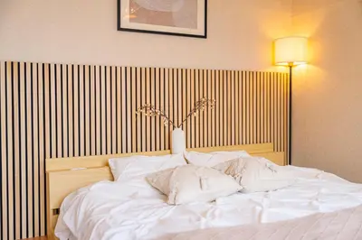 a large white bed with a vase on top of it at #34-Zen Home- \u6771\u745e\u6c5f in Tokyo