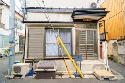 a house with a yellow pole in front of it at #34-Zen Home- \u6771\u745e\u6c5f in Tokyo