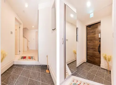 a hallway with a glass door and a tile floor at \u6625\u65e5\u5c45 Kasuga House in Tokyo