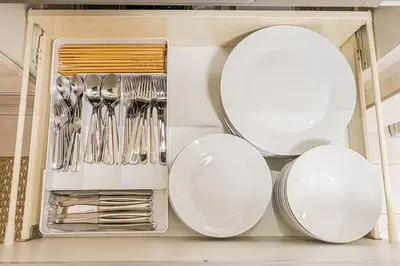 a drawer with plates and utensils in a kitchen at \u6625\u65e5\u5c45 Kasuga House in Tokyo