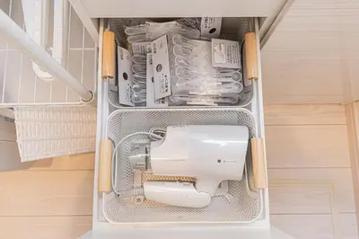 a sewing machine sitting inside of a refrigerator at \u6625\u65e5\u5c45 Kasuga House in Tokyo
