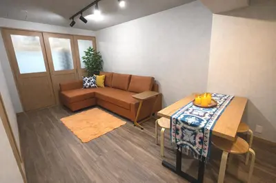 a living room with a couch and a table at #6 WiFi無料&新宿5分! 清潔 安全 お洒落な部屋! in Tokyo