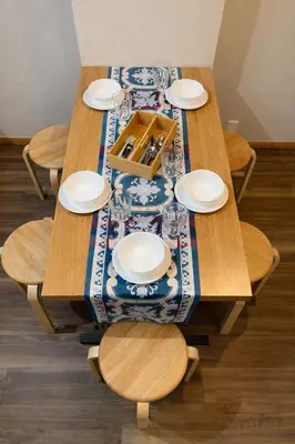 a wooden table with plates and glasses on it at #6 WiFi無料&新宿5分! 清潔 安全 お洒落な部屋! in Tokyo