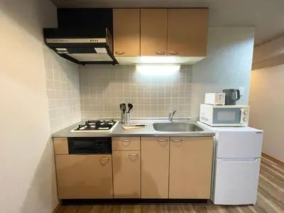 a small kitchen with a sink and a microwave at #6 WiFi無料&新宿5分! 清潔 安全 お洒落な部屋! in Tokyo