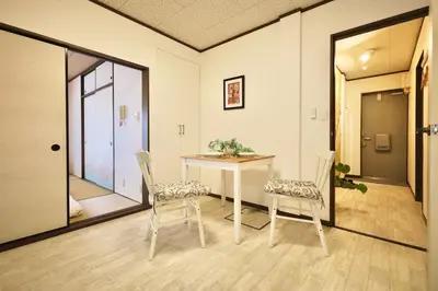 a dining room with a table and two chairs at \u30a8\u30de\u30fc\u30ec\u6771\u5c0f\u5ca9103 \u5c0f\u5ca9\u99c5\u5f92\u6b695\u5206 \u6700\u59275\u540d \u548c\u5ba4\u7573 in Tokyo