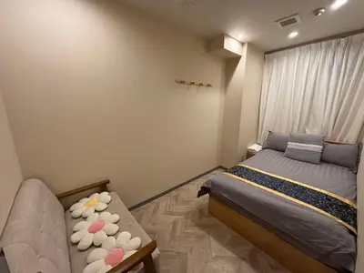 a bedroom with a bed and a couch at \u53f0\u6771\u533a\u30a2\u30d1\u30fc\u30c8\u30e1\u30f3\u30c8 in Tokyo