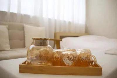 a wooden tray with two glass jars on a table at \u53f0\u6771\u533a\u30a2\u30d1\u30fc\u30c8\u30e1\u30f3\u30c8 in Tokyo