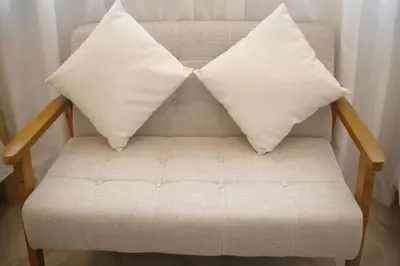 a couch with two pillows on top of it at \u53f0\u6771\u533a\u30a2\u30d1\u30fc\u30c8\u30e1\u30f3\u30c8 in Tokyo