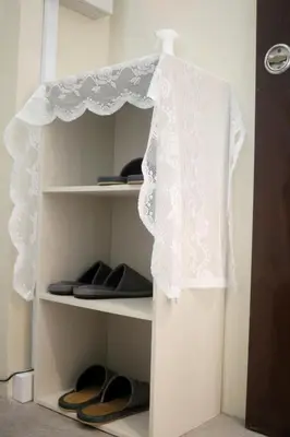 a white wedding dress is hanging on a closet at \u53f0\u6771\u533a\u30a2\u30d1\u30fc\u30c8\u30e1\u30f3\u30c8 in Tokyo