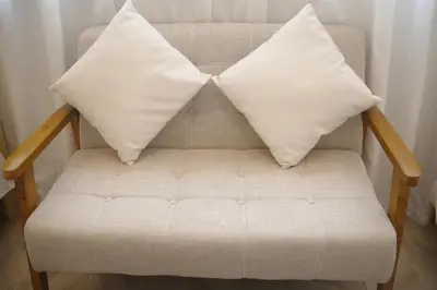 a couch with two pillows on top of it at \u53f0\u6771\u533a\u30a2\u30d1\u30fc\u30c8\u30e1\u30f3\u30c8 in Tokyo