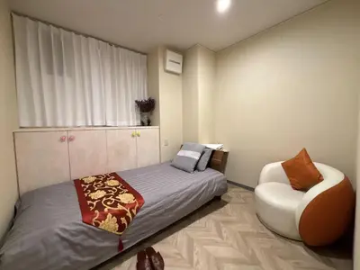 a bedroom with a bed and a chair at \u53f0\u6771\u533a\u30a2\u30d1\u30fc\u30c8\u30e1\u30f3\u30c8 in Tokyo
