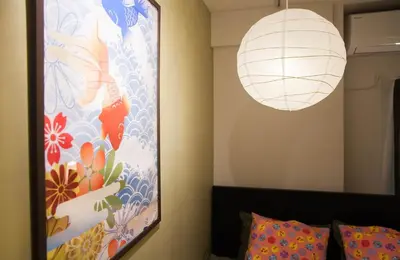 a bedroom with a large painting and a lamp at Imb\u753a\u5c4b4\u4e01\u76ee102 in Tokyo