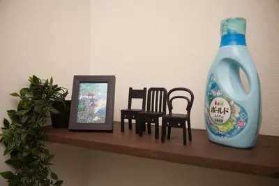 a shelf with chairs and a blue bottle and a picture at Imb\u753a\u5c4b4\u4e01\u76ee102 in Tokyo