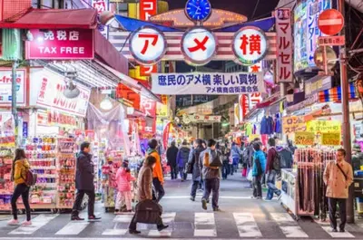 a group of people walking through a market with signs at Imb\u753a\u5c4b4\u4e01\u76ee102 in Tokyo