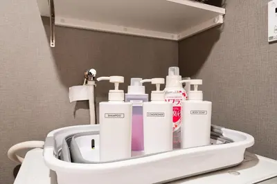 a bathroom with a bunch of toiletries in a holder at Jeminith Ikebukuro Tokyo in Tokyo
