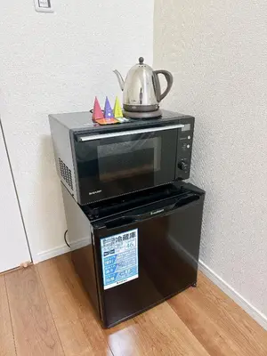 a microwave with a tea kettle on top of it at HB Home TOKYO in Tokyo