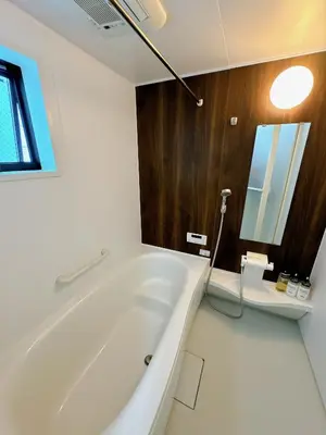 a white bath tub in a bathroom with a window at HB Home TOKYO in Tokyo