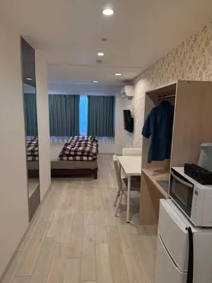 a living room with a kitchen and a bedroom at The Asakusa Townhouse in Tokyo