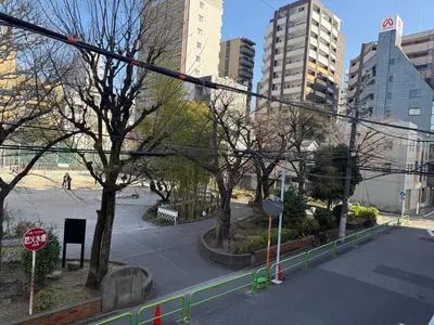 a city street with a stop sign and buildings at The Asakusa Townhouse in Tokyo