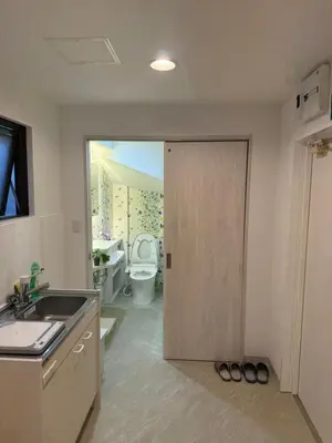 a bathroom with a door leading to a bathroom with a toilet at The Asakusa Townhouse in Tokyo