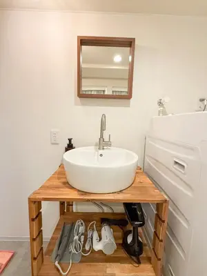 a bathroom with a sink and a mirror at 52 House Shimbashi in Tokyo