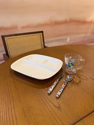 a plate and two spoons on a wooden table at 52 House Shimbashi in Tokyo