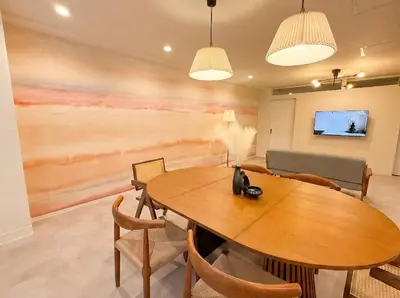 a dining room with a wooden table and chairs at 52 House Shimbashi in Tokyo