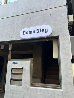 a sign that says dumbo stay on a building at Domo Stay in Tokyo
