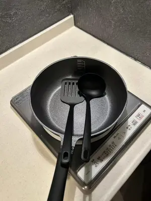 a frying pan and spatula sitting on a counter at Domo Stay in Tokyo