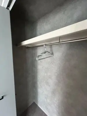 a shower with a towel rack on a wall at Domo Stay in Tokyo