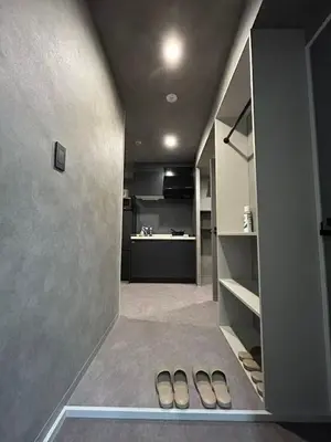 a hallway with two pairs of shoes in a kitchen at Domo Stay in Tokyo