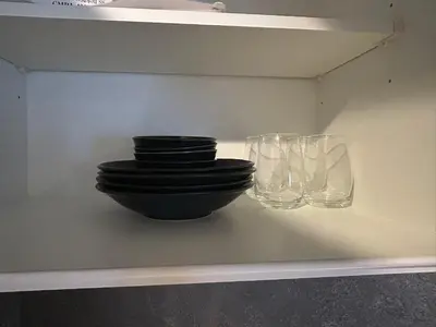 a shelf with a bowl and two glasses on it at Domo Stay in Tokyo