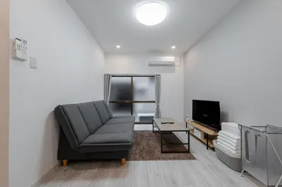 a living room with a chair and a television at -Imado- Within walking distance of Asakusa Station and Tokyo Skytree! in Tokyo
