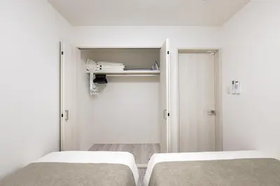 two beds in a small room with white walls at -Imado- Within walking distance of Asakusa Station and Tokyo Skytree! in Tokyo
