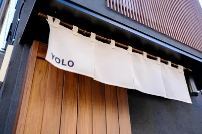 a door with a volo banner on it at Yolo Asakusa Stay in Tokyo