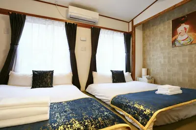two beds in a room with windows at Newly Renovated & Yamanote Line Sugamo 7 Minute Walk in Tokyo