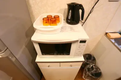 a white microwave with food on top of it at Newly Renovated & Yamanote Line Sugamo 7 Minute Walk in Tokyo