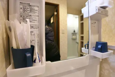 a mirror on a wall in a bathroom at Newly Renovated & Yamanote Line Sugamo 7 Minute Walk in Tokyo