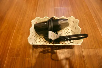a wine bottle in a white holder on a wooden floor at Newly Renovated & Yamanote Line Sugamo 7 Minute Walk in Tokyo