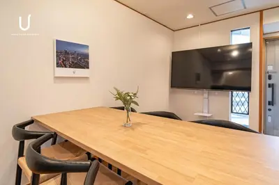 a conference room with a wooden table and chairs at unito villa SHINJUKU in Tokyo