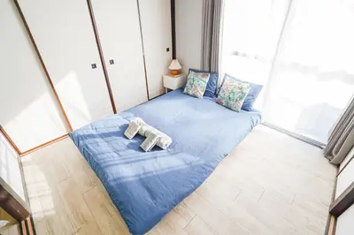 a room with a blue bed with two towels on it at 402Room 1 Stop from Ikebukuro Entire 35m on 4st Floor 2 Bedrooms for up to 6 Guests 3Minute Walk to Don Quijote in Tokyo