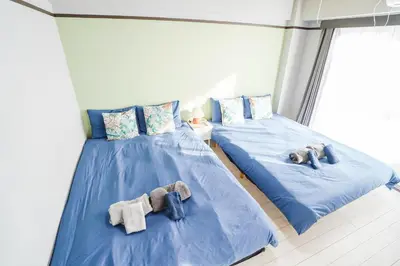 two beds with stuffed animals on them in a room at 402Room 1 Stop from Ikebukuro Entire 35m on 4st Floor 2 Bedrooms for up to 6 Guests 3Minute Walk to Don Quijote in Tokyo