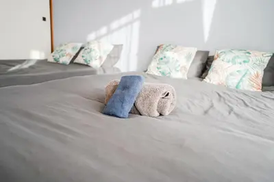 a stuffed animal is laying on a bed at 403Room 1 Stop from Ikebukuro Entire 35m on 4st Floor 2 Bedrooms for up to 6 Guests 3Minute Walk to Don Quijote in Tokyo